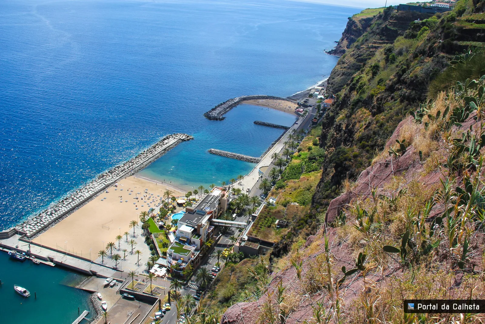 The promenade behind the sand at Praia da Calheta