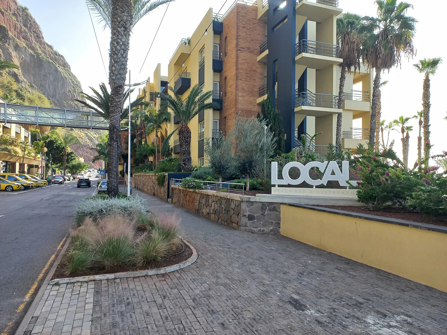 Hotel buildings above the harbour and beach at Calheta