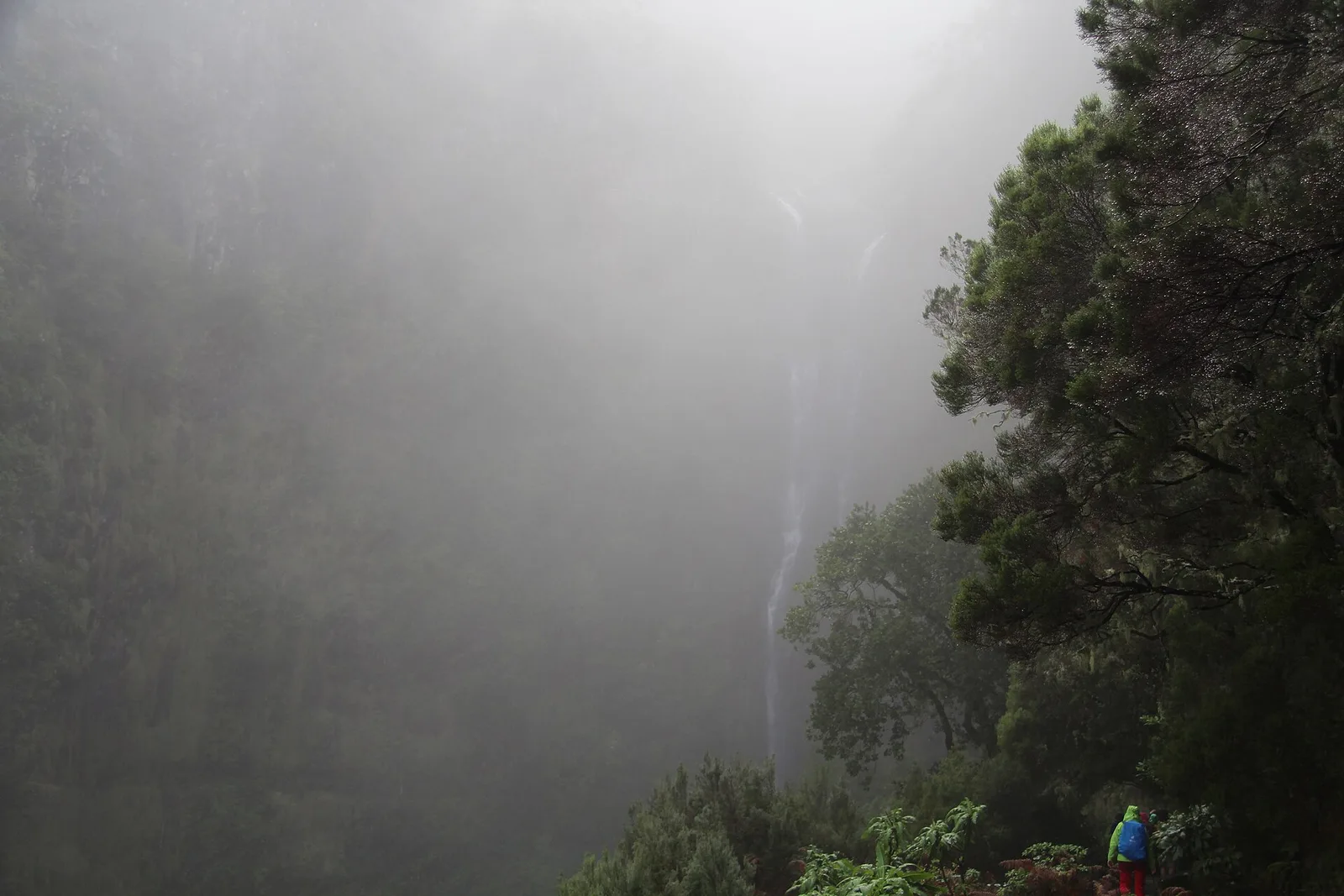 The Risco waterfall dropping through mist on the wall above the Rabaçal valley
