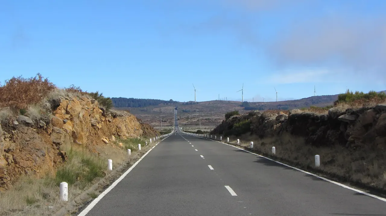 The road across the Paul da Serra plateau with wind turbines on the skyline