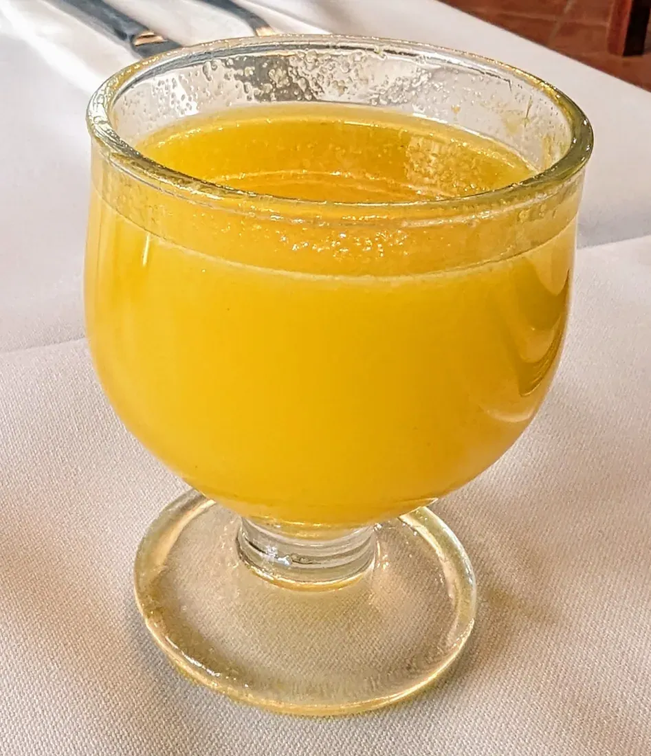 A glass of poncha, Madeira's sugar-cane rum, honey and citrus drink