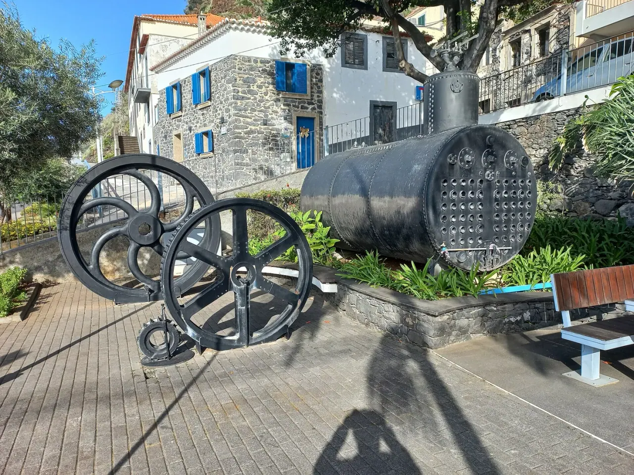 Industrial memorial machinery on the harbour front at Calheta